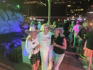 3 women smiling at a cancer vaccine coalition event