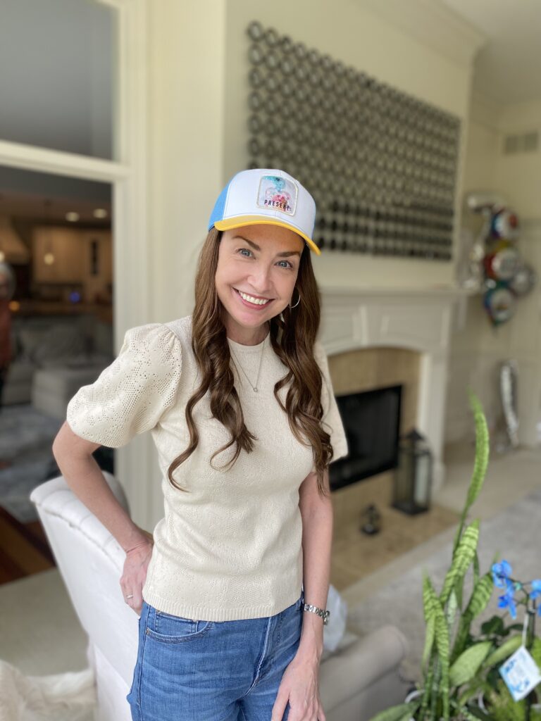 a woman smiling wearing a lizzielu hat